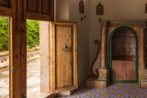 Sicily - Sunny impressions of the Aeolian Islands, also known as Aeolian Islands or Isole Eolie: Lipari, Stromboli, Salina, Vulcano, Panarea, Filicudi and Alicudi. Entrance to the church through a wooden door on Panarea. Old confessional. Sicily - Sunny impressions of the Aeolian Islands, also known as Aeolian Islands or Isole Eolie: Lipari, Stromboli, Salina, Vulcano, Panarea, Filicudi and Alicudi. Entrance to the church through a wooden door on Panarea. Old confessional.